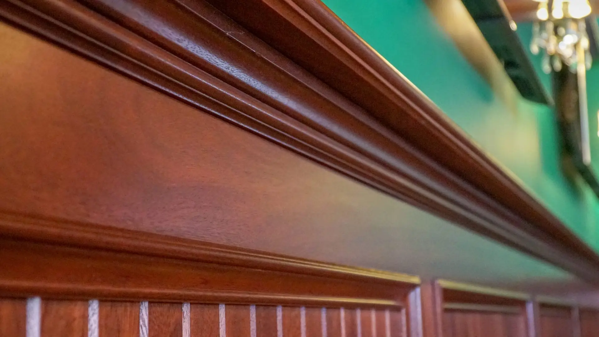 Stained crown moulding above beadboard panelling